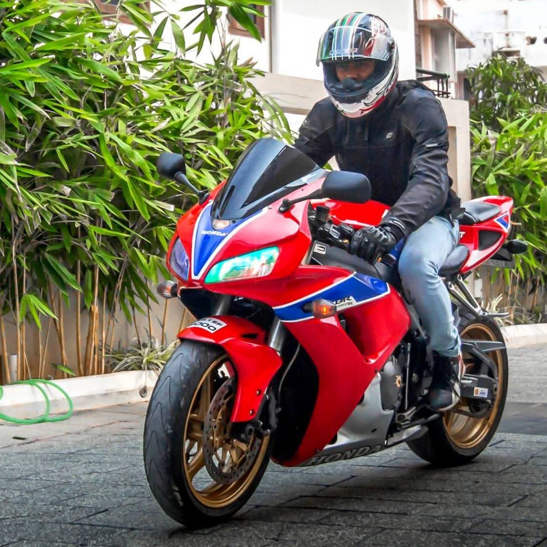 Venkata Aravind riding a red motorcycle